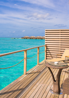 Overwater villa deck above a turquoise lagoon